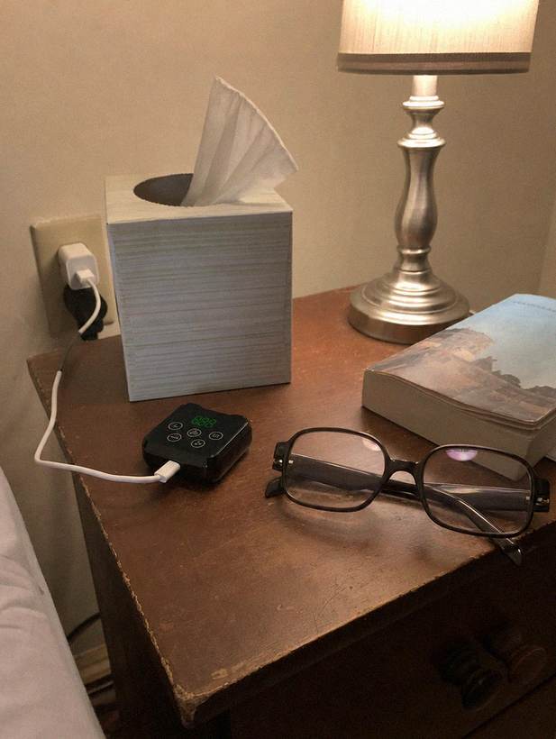 Customer photo: pod charging on the nightstand
