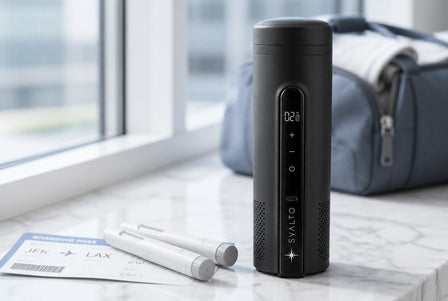 Svalto Cooler Pro on a marble windowsill beside two injection pens and a boarding pass