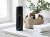 Svalto Cooler Pro on a bathroom vanity beside a travel toiletry bag