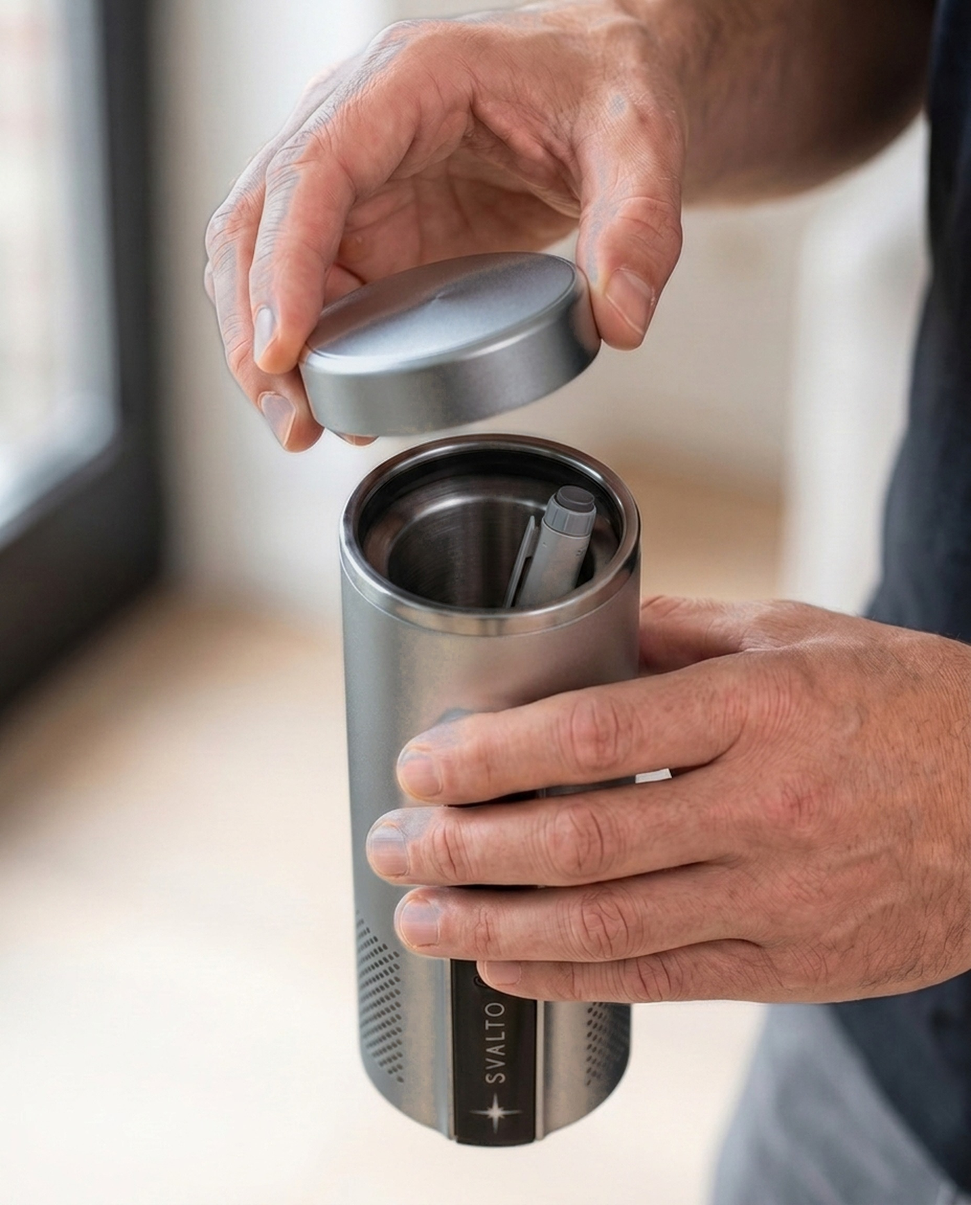Titanium Svalto Cooler Pro — cap being removed by hand