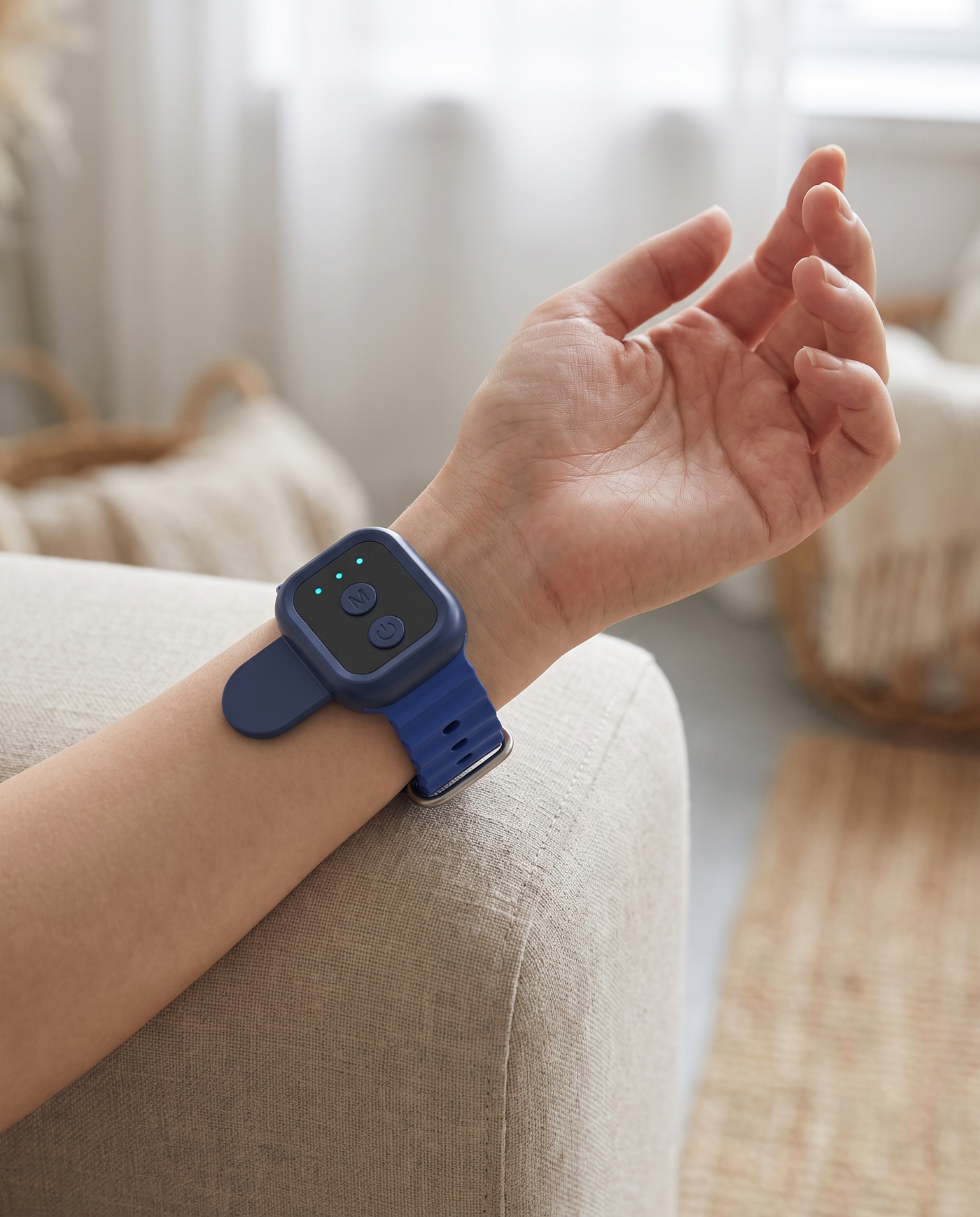Svalto Steady worn on the inner wrist at home on a linen sofa