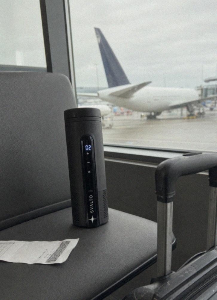 Svalto Cooler Pro on an airport departure-gate seat beside a carry-on, customer photo